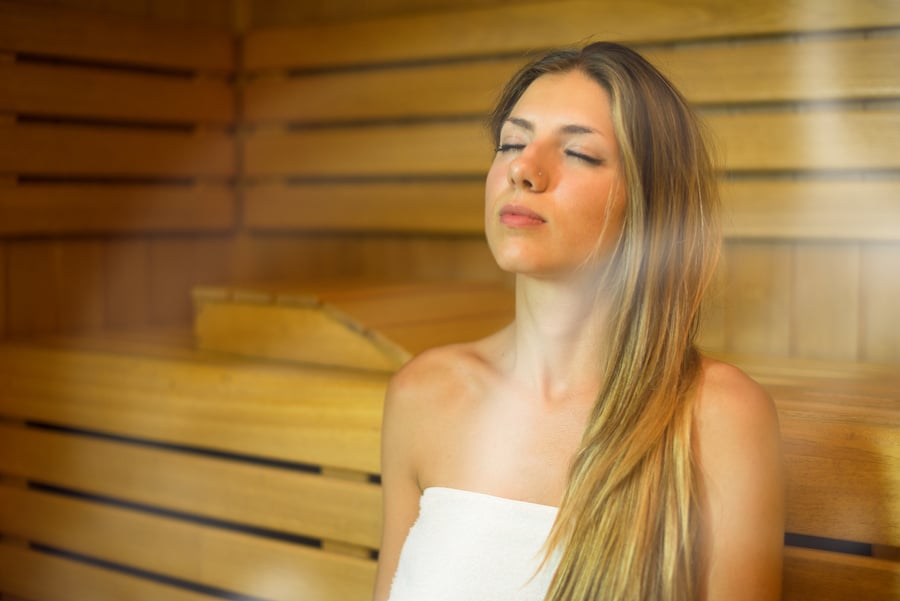 Beautiful Woman Having a Sauna Bath in a Steam Room